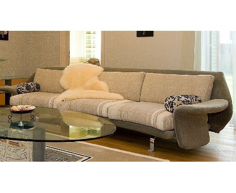 A contemporary Fly Il Loft three seater linear upholstered sofa in supple fluent shapes with arched back and convexed profile