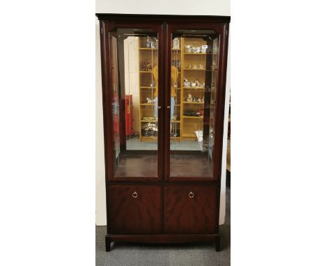 A Stag mahogany glazed cabinet, W. 96cm H. 183cm.