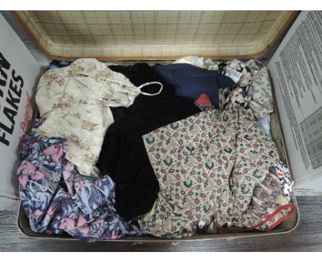 A vintage suitcase containing a quantity of ladies modern and retro skirts, blouses dresses and similar. good condition in mi