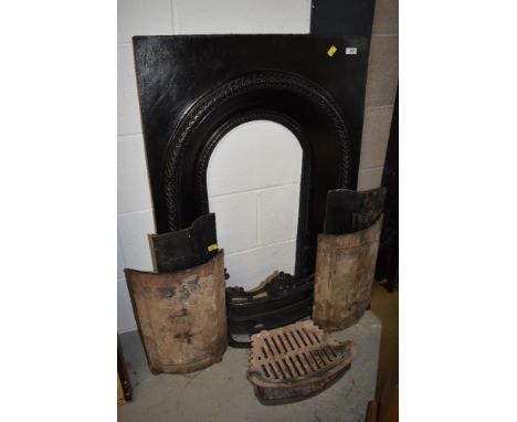 A cast iron fire surround, grate etc