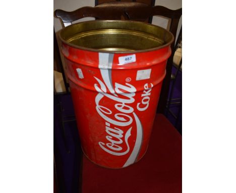 A vintage waste paper bin advertising coca cola