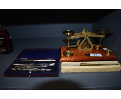 A selection of desktop items including letter scale geometry set and ink pens