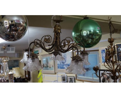 An early 20th century brass five branch ceiling light, with crackle glass shades.  Condition Report: the light appears to be 