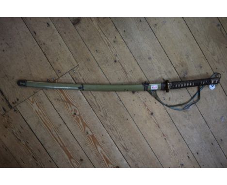 A Japanese World War II period sword and scabbard. Condition Report: We do not believe this is a replica. We cannot remove th