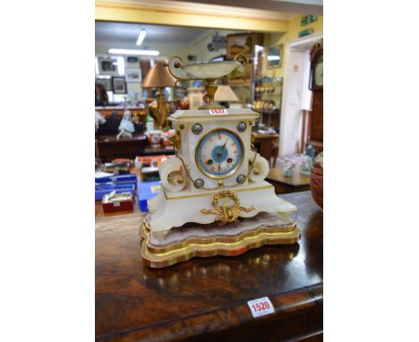 A late 19th century onyx and gilt brass mounted mantel clock, 30cm high, on giltwood stand.