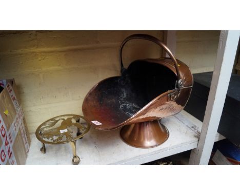 A Victorian copper helmet form coal scuttle; together with a brass trivet. 