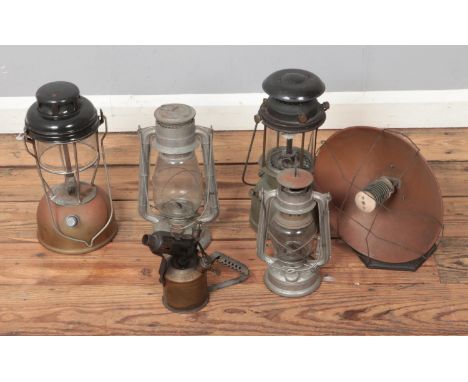 Four Tilley lamps along with a copper lined heat lamp on cast iron stand.  