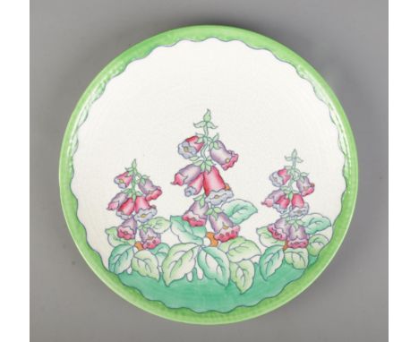 Charlotte Rhead for Crown Ducal, a ceramic charger decorated with Foxgloves, pattern number 4953. Diameter 32cm.  Crazing. No