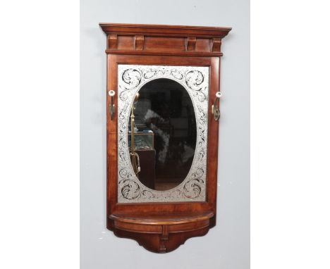 A mahogany framed hall mirror. Having etched glass border, coat hooks and shelf. Length 102cm.  