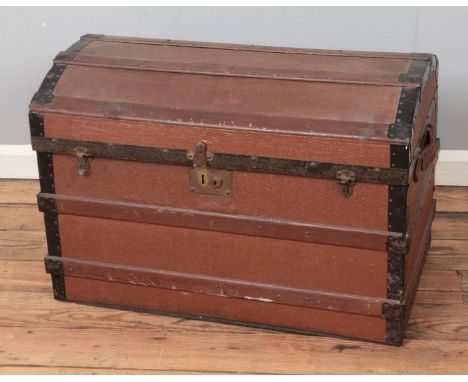 A vintage dome top wooden bound trunk.  