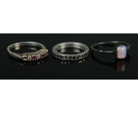 Three silver rings, one set with opal stone. Sizes JÂ½, O and PÂ½. Total weight: 5.3g  