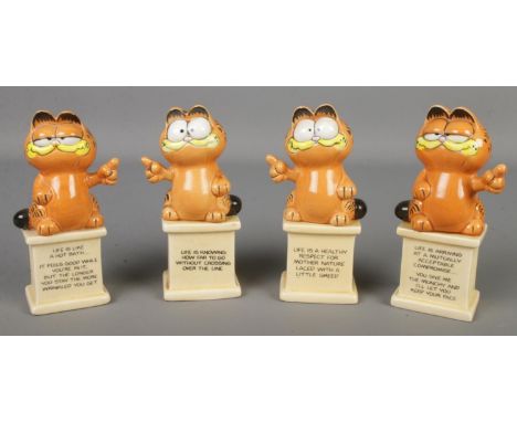 Four ceramic Garfield figures.  