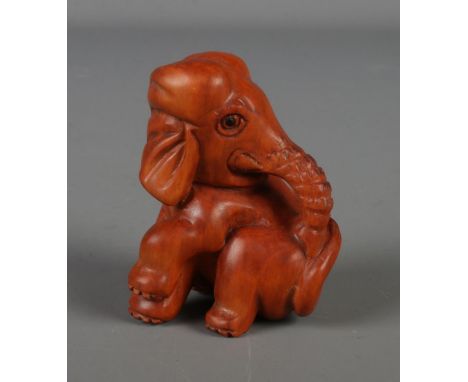 A Japanese carved Netsuke in the form of a elephant.  