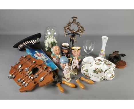 A box of mixed collectables including spoons on rack, glass dome, candlestick, Staffordshire character jugs, porcelain doll, 