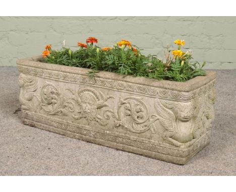 A rectangular cast concrete planter decorated with mythical creatures. Height 26.5cm, Length 73cm, Depth 24cm.  