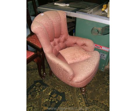 A 19th c. Parlour Armchair having button back and arms upholstered in pink floral shadow pattern fabric and standing on turne