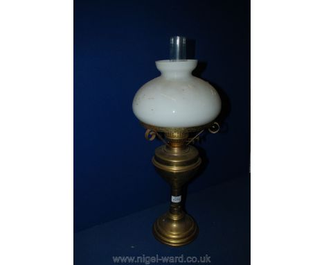 A Brass Oil Lamp with milky white glass shade and clear glass chimney, 23" tall