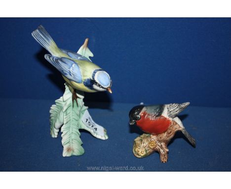 A Goebel Blue Tit perched on a large leaf, and a Beswick Bullfinch