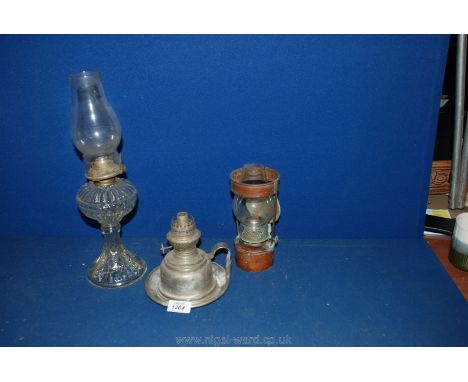 A glass Oil Lamp with honeycomb effect, a Copper wall hanging oil Lamp and a Chamberstick Oil Lamp