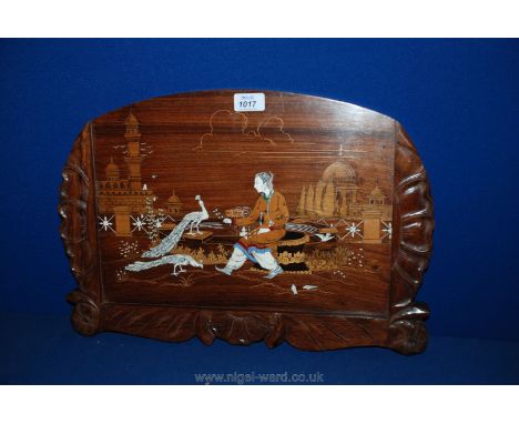 An Indian carved and inlaid wooden Wall Plaque depicting a girl in a garden by a fountain with peacocks