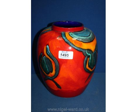 A large Poole pottery Vase in reds, blue and orange colours, 9" tall