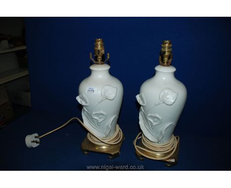 A pair of white Table Lamps with brass scrolled base, the lamp decorated with lilies, 15 1/2" tall