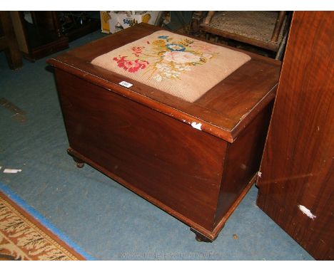 A 19th c. style Mahogany Box Ottoman with central floral tapestry fabric seat to the lid.  28" wide x 20" high x 20" deep.