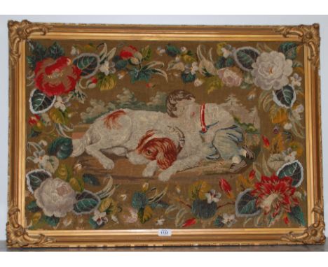 A large Wool-work and bead Tapestry circa 1860 of a boy in a wooded grove asleep with his hound, in original frame, 32" x 22"