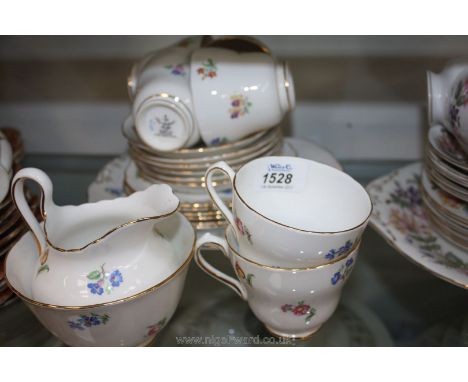 A six place setting Teaset by New Chelsea, Staffordshire, white ground with pretty floral design including bread/butter plate