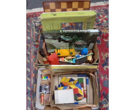 Two boxes containing wooden chess board, building blocks, crayons, xylophone, wooden trains, Subbuteo table, Waddingtons, For