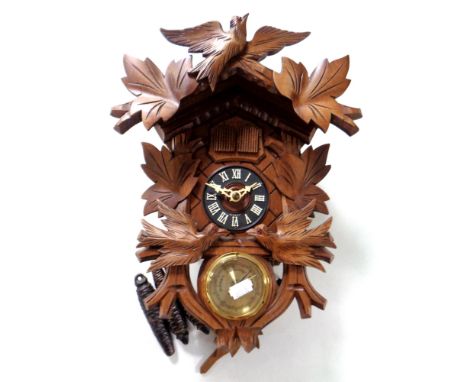 A cuckoo clock with pendulum and weights 