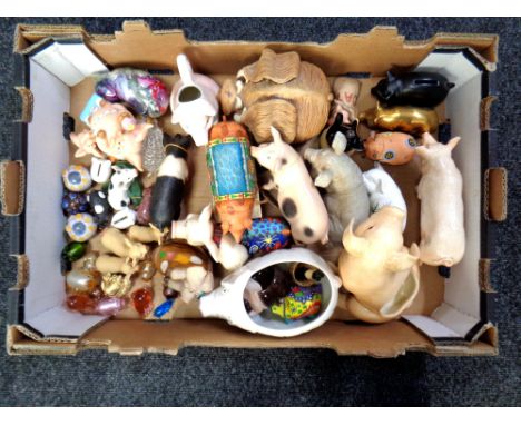 A box containing ceramic glass and resin pig ornaments to include Leonardo, Country Artists, brass examples. 