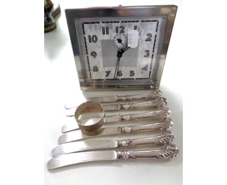 A twentieth century Scottish LSM chrome plated alarm clock together with a set of six handled butter knives and a silver napk