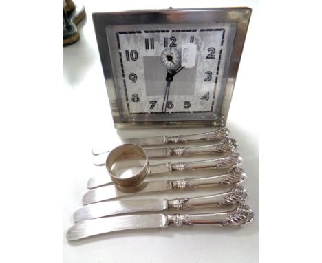 A twentieth century Scottish LSM chrome plated alarm clock together with a set of six handled butter knives and a silver napk