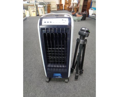 An air-conditioning unit together with a camera tripod. 