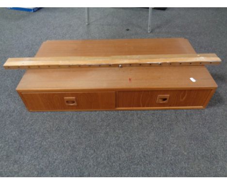 A mid-twentieth century wall-mounted shelf fitted two drawers.  