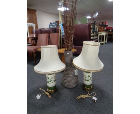 A pair of brass and ceramic table lamps with shades together with a floor-standing vase containing sticks. 