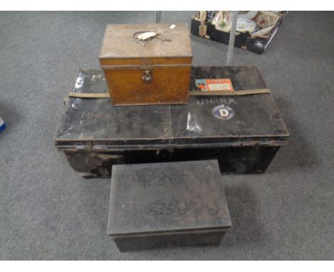 An antique tin trunk bearing Cunard line labels, together with two further metal deed boxes 