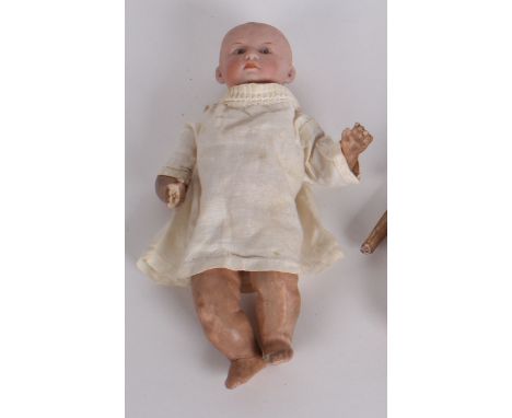 A bisque head baby doll marked Germany 106 with fixed eyes (25cm) and a part Chinese puppet (2)