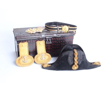 A Naval Officers uniform comprising a black moleskin bi-corn hat with gilt embellishments, the inner silk lining with Gieves 