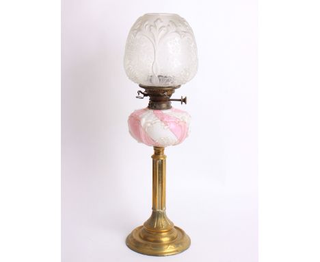 A Victorian paraffin lamp with a brass column, a white and pink glass reservoir and a etched glass shade, height 66cm