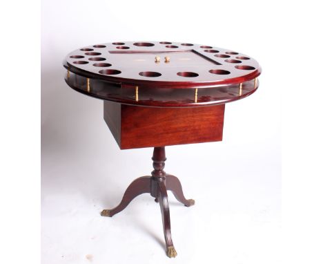 A modern inlaid mahogany drinks table, the circular top with bottle stands around a concealed cellaret, on tripod stand, top 