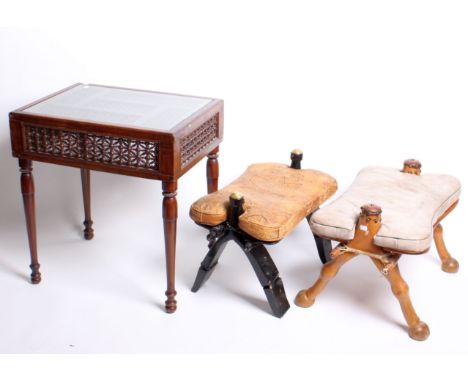A Middle Eastern panel coffee/lamp table with Mashrabiya lattice decoration and two camel stools