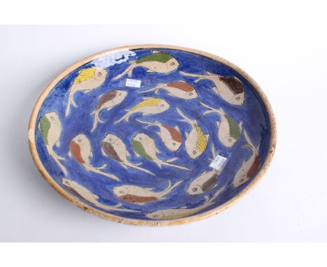 A Far Eastern ceramic charger decorated with fish, brassware, a Japanese fan with topographical scenes and a resin model 