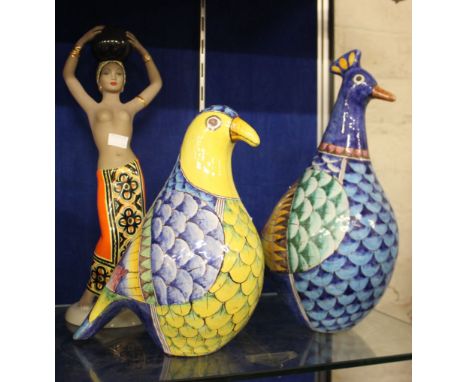 Two large pottery birds, colourfully decorated, height approximately 37cm and a ceramic figure: Matha, Orino, titled 'Dihulp'