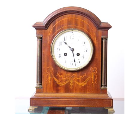 An Edwardian mahogany and inlaid arch top mantel clock with two train movement, gong strike and enamel dial, h: 32cm, w: 26cm