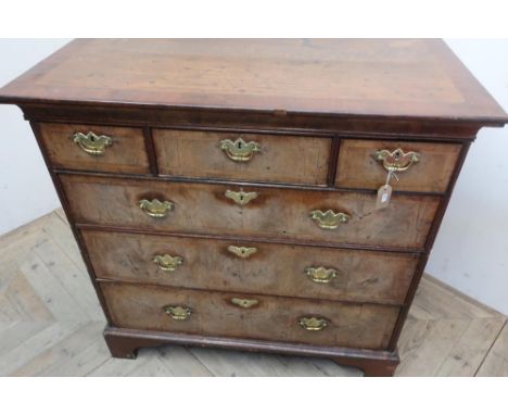 18th C cross and feather banded walnut chest with moulded top above three short and three long drawers with brass handles, on