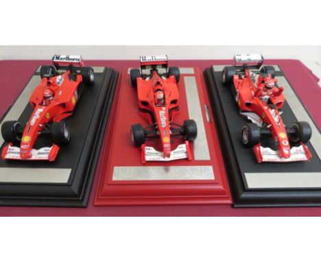 Hot Wheels 1:18 scale model Ferrari's Michael Schumacher World Champion 2000, 2001, 2002, on plinths with circuit victory pla