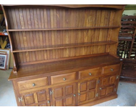 Cryer Craft elm dresser with twin shelf back above four drawers and four four-panelled doors on plinth base with panel sides 