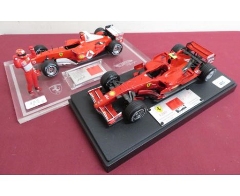 Hot Wheels 1:18 scale model Ferrari F2007 limited edition 1620/5555, and another, both on plinths and with a section of an au